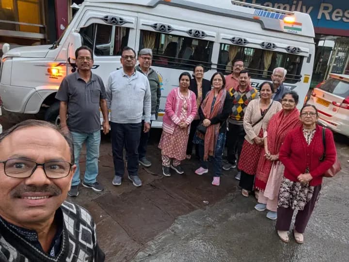 Happy multi-generational family standing alongside their sanitized Force Traveller