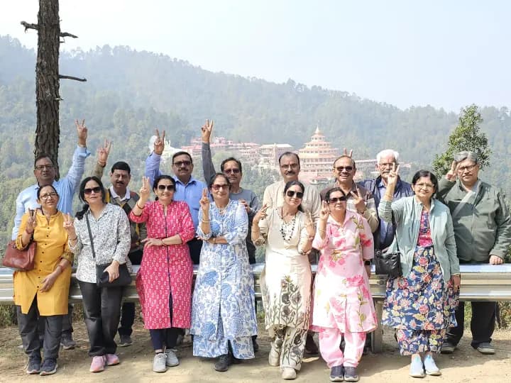 Cheerful devotees waving from a mountain ridge road with evergreen pine forest view