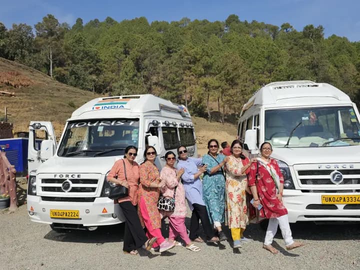 Pilgrims enjoying a tea break beside two matched Shree Tungnath Force Travellers