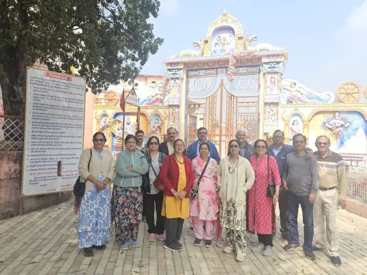 Devotee yatra party gathering before the ornate mandir pravesh dwar