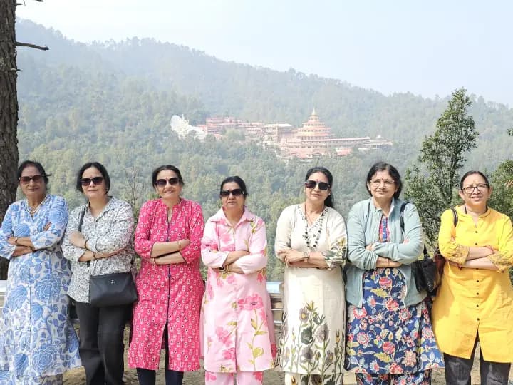 Women pilgrims in vibrant attire standing united during sacred domestic pilgrimage