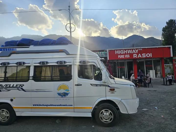 Shree Tungnath Force Traveller parked outside Highway Rasoi with mountain peaks on horizon